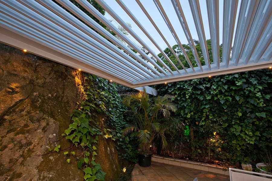 Private backyard area in Mosman covered by an opening roof pergola.
