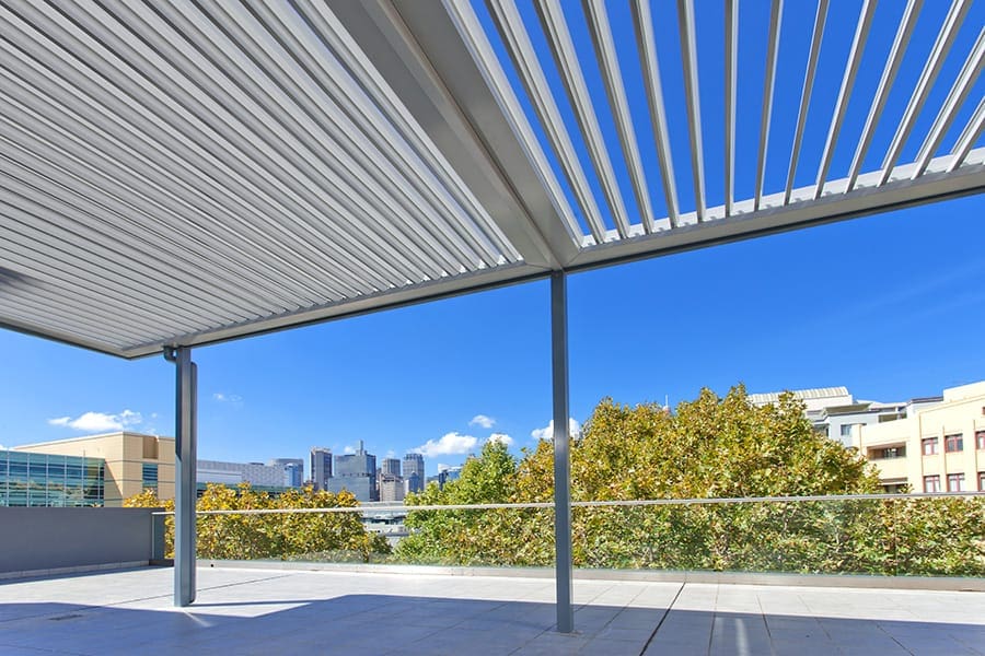 Simple Pyrmont awning with opening roof louvres, installed on an apartment building top level.