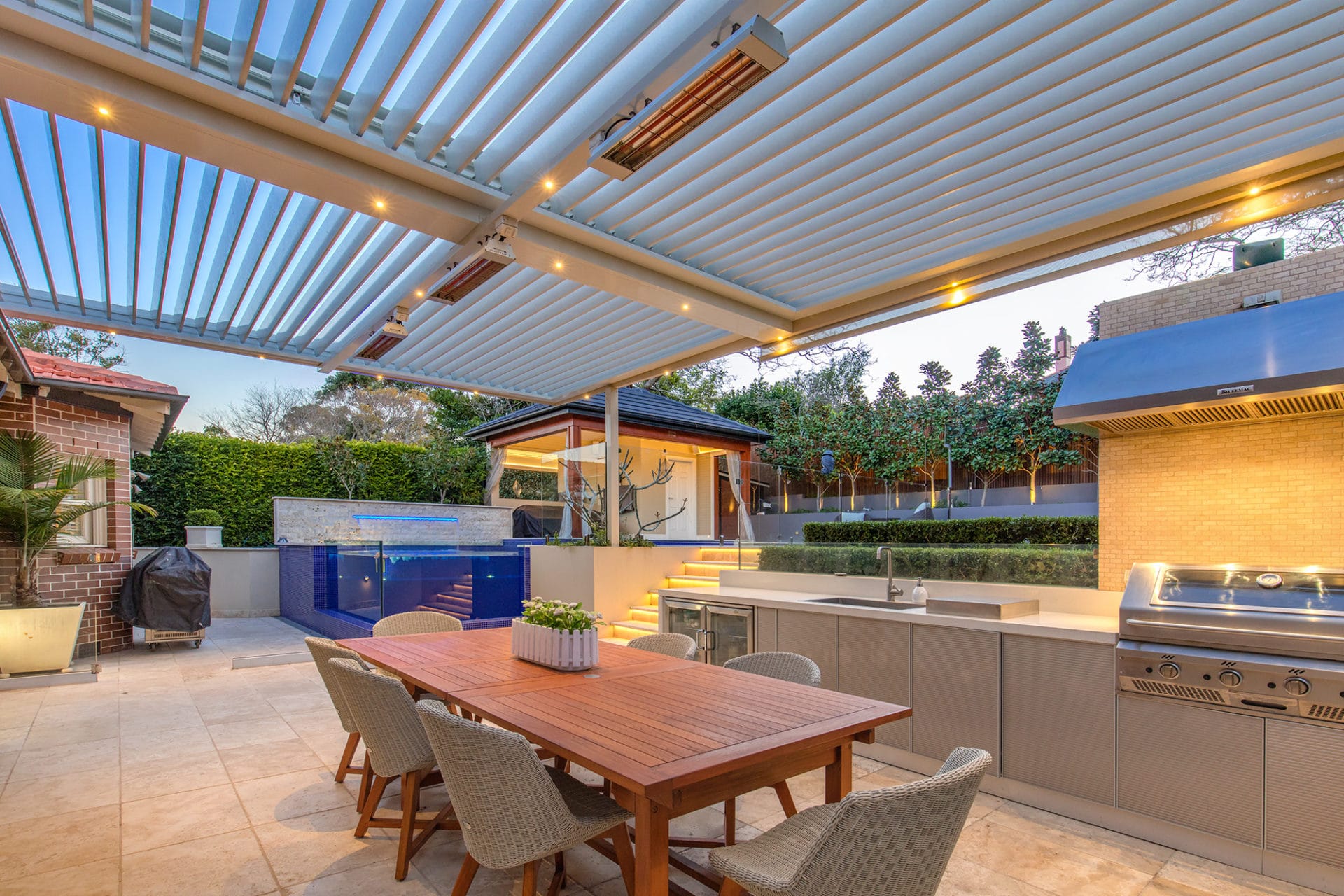 Haberfield pergola with louvre roof system, outdoor heating, down lights, outdoor BBQ and kitchen.