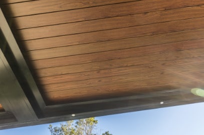 Quality woodgrain aluminium roof louvres on opening roof pergola.