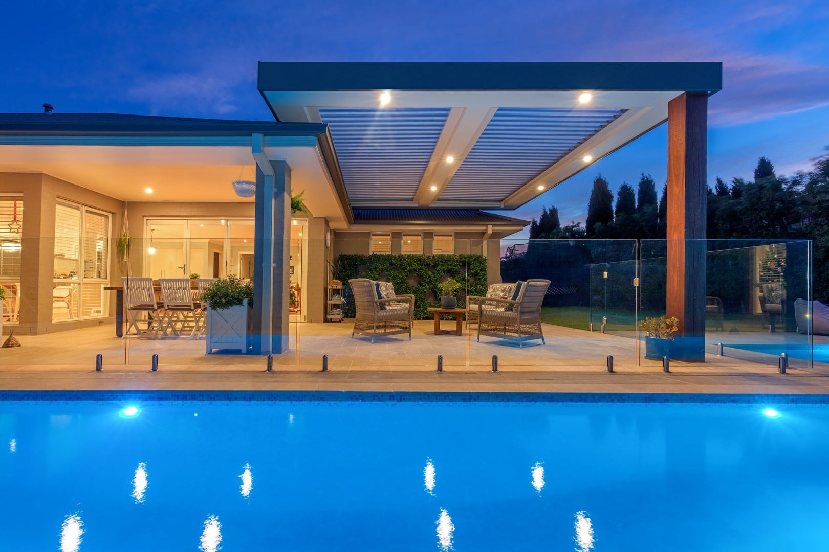 Opening roof in outdoor area with pool and down lights