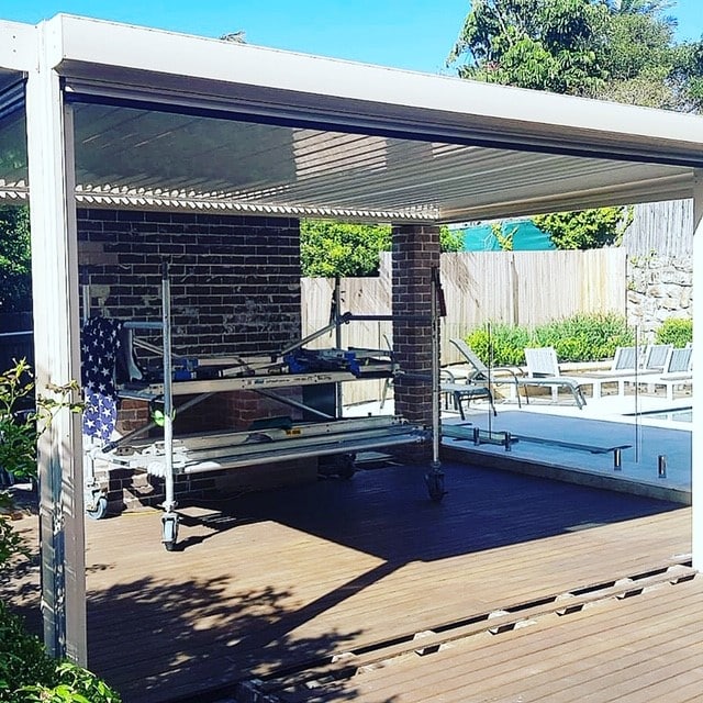 Opening roof system in outdoor area with pool and deck