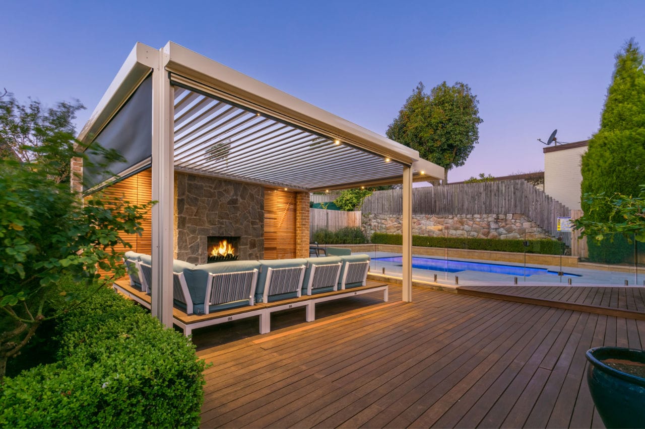 Killarney Heights pergola with built on timber decking, with fireplace, LED lights and outdoor blinds.