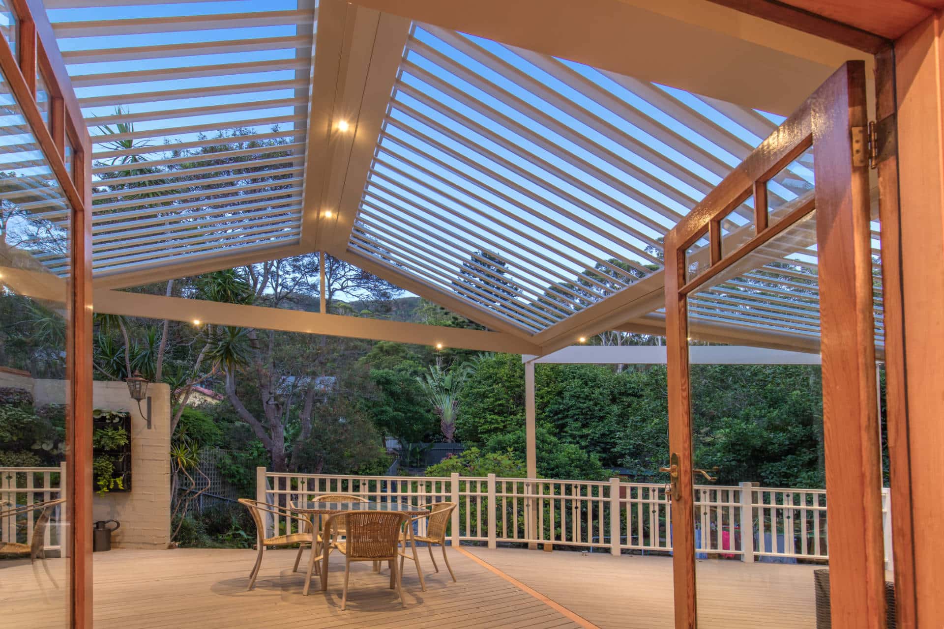 Austinmer pergola with open louvres at dusk.