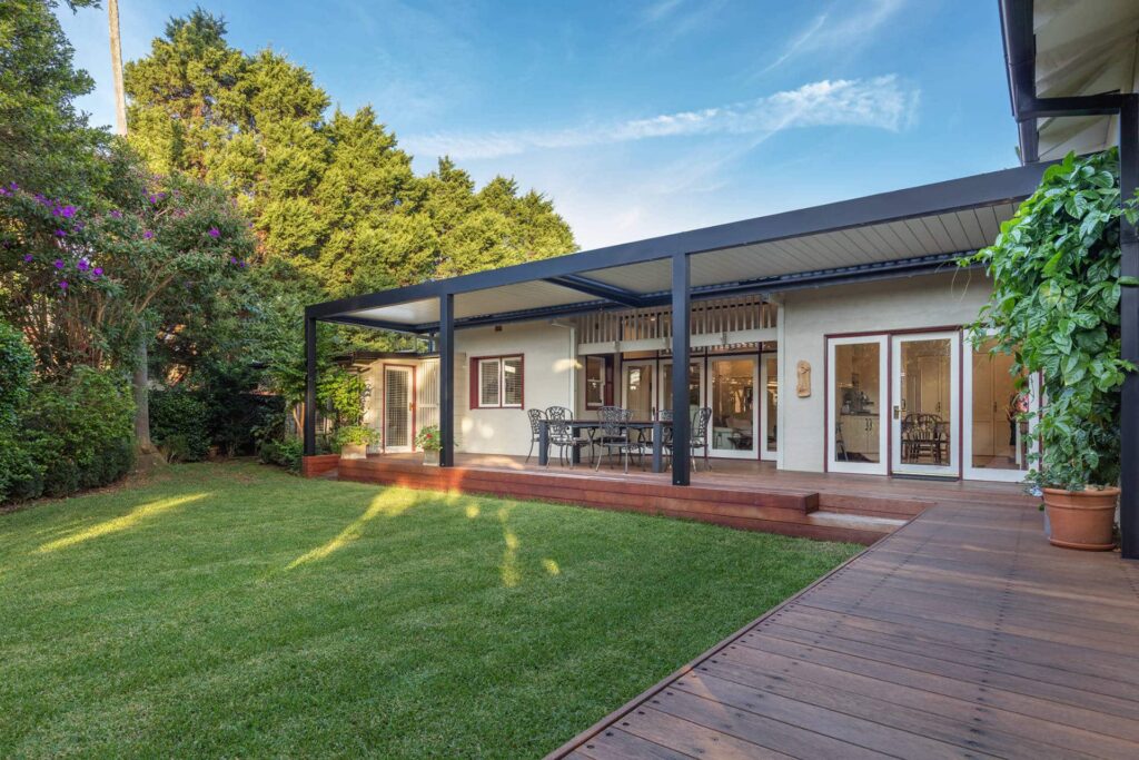 Chatswood pergola with grey frame and creme coloured louvres.