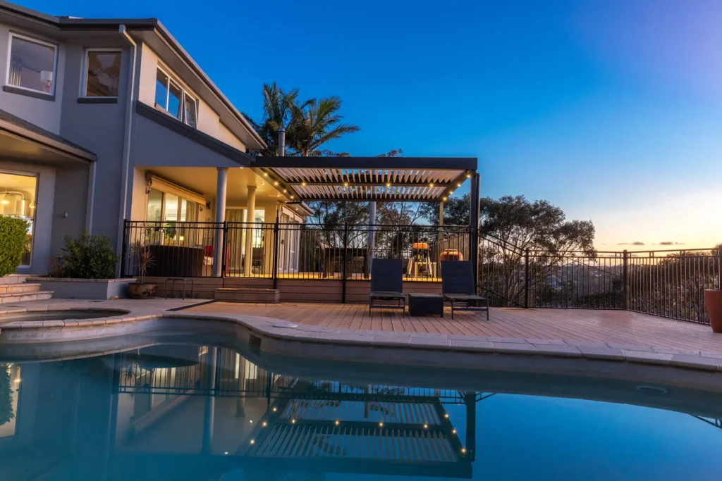 Photo of a Beacon Hill home with a new opening roof pergola by poolside at sunset