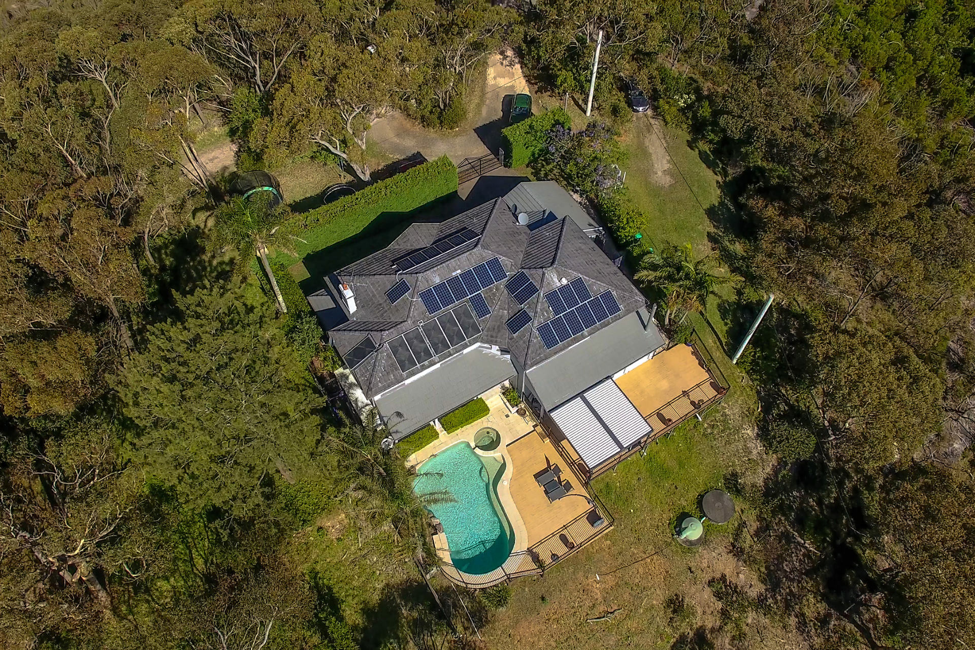 An aerial shot of a Beacon Hill home with pool and newly installed opening roof pergola