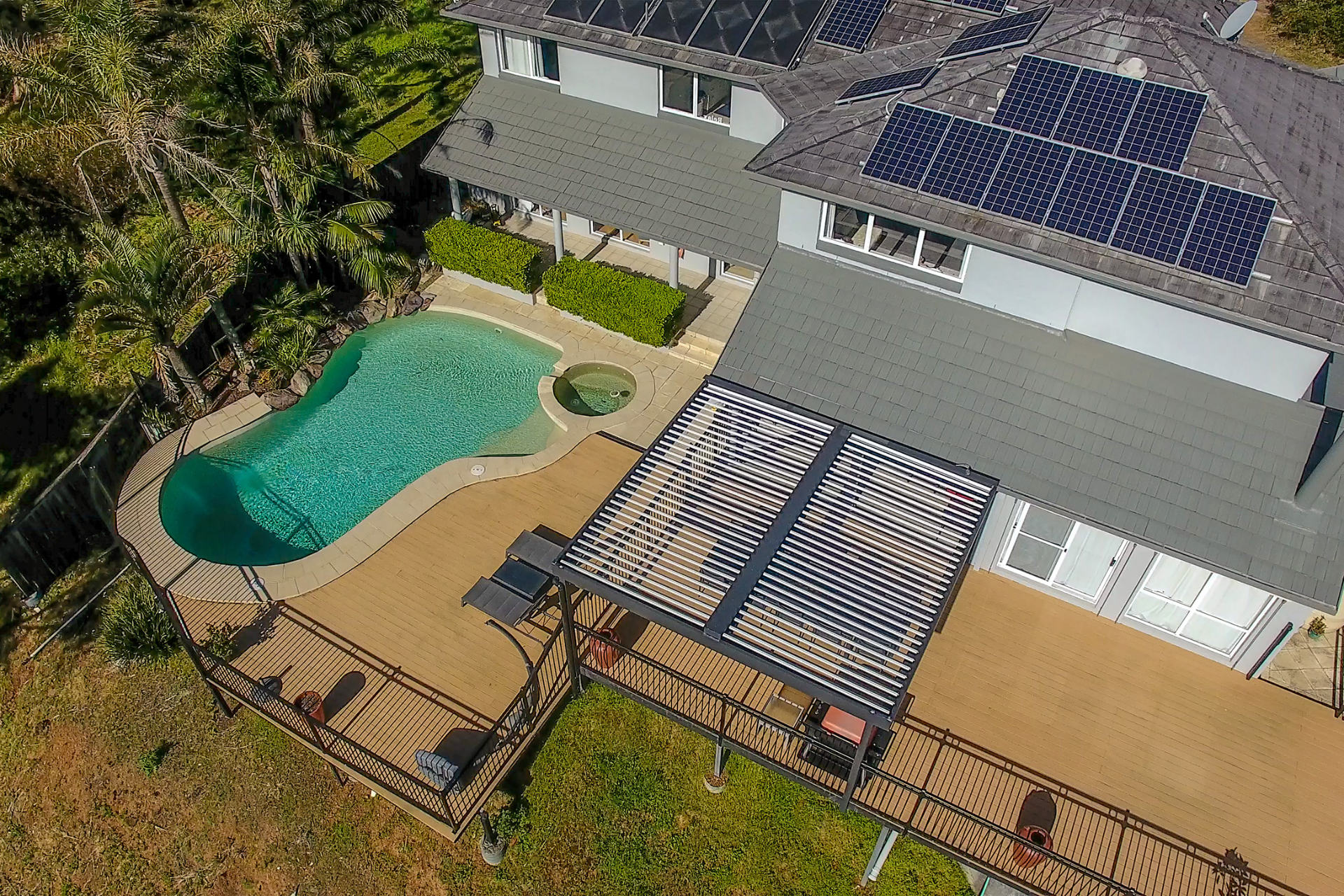 Aerial shot of home and pool with a new opening roof pergola