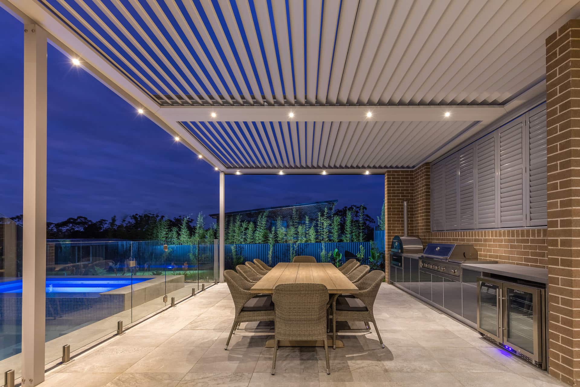 A North Kellyville home at night with new opening roof pergola with integrated LED lighting