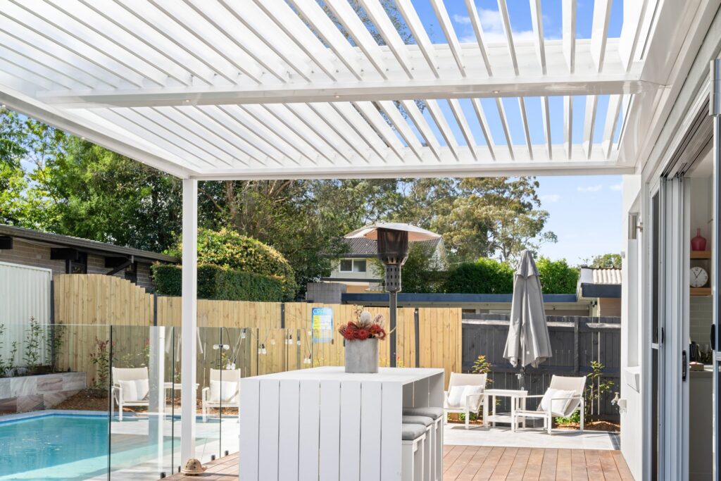 Pearl White louvre roof over St Ives poolside decking from under the roof.