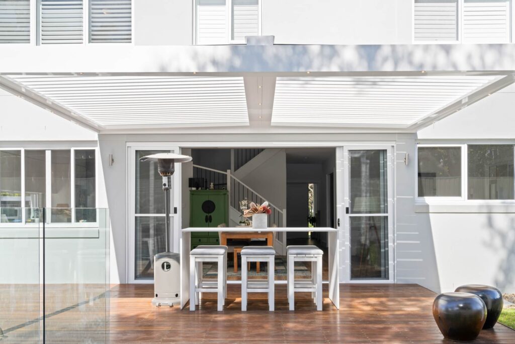 Pearl White louvre roof over St Ives poolside decking with timber deck.