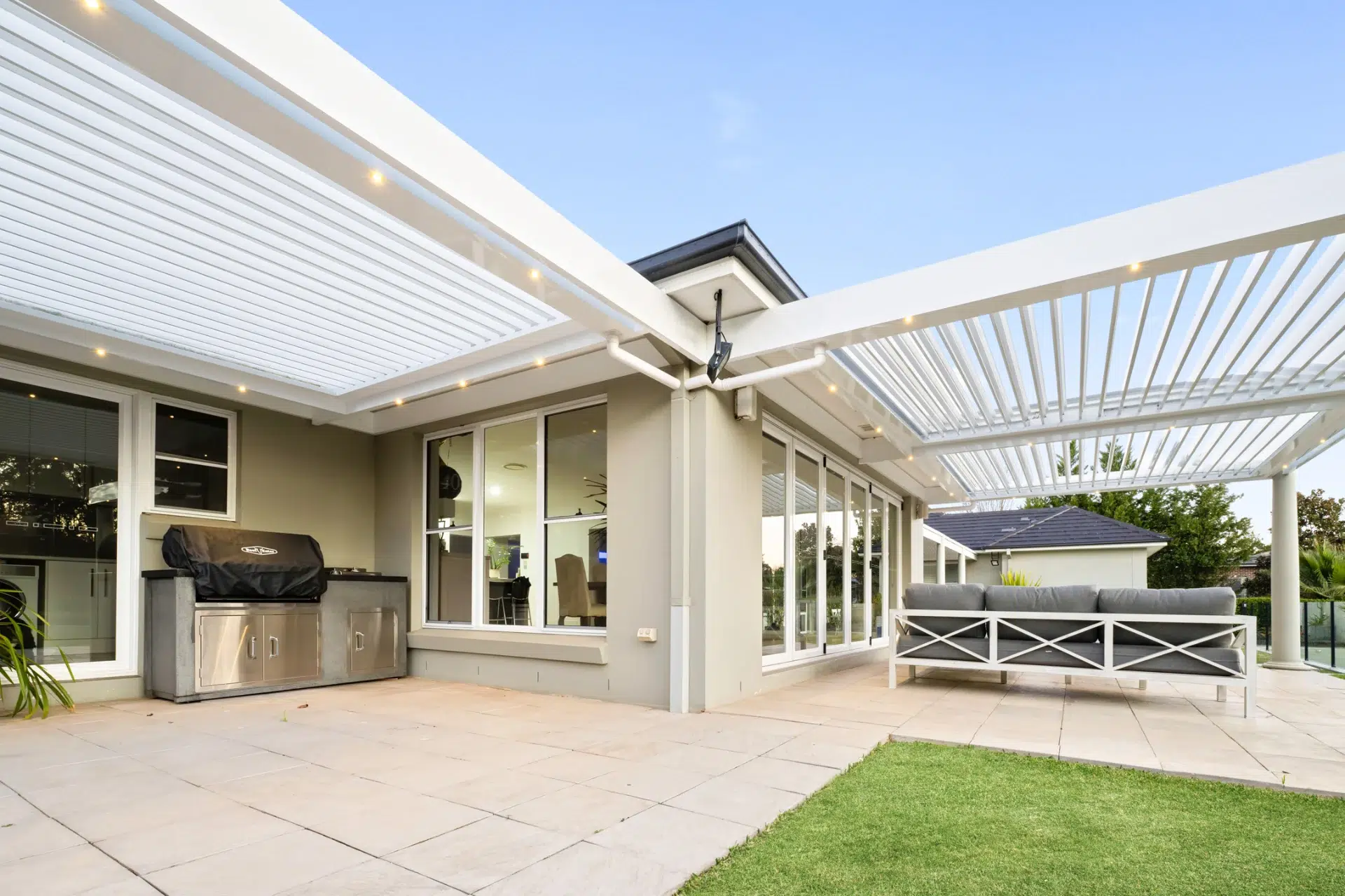 Two professionally installed louvre roofs attached to adjacent sides of the house.