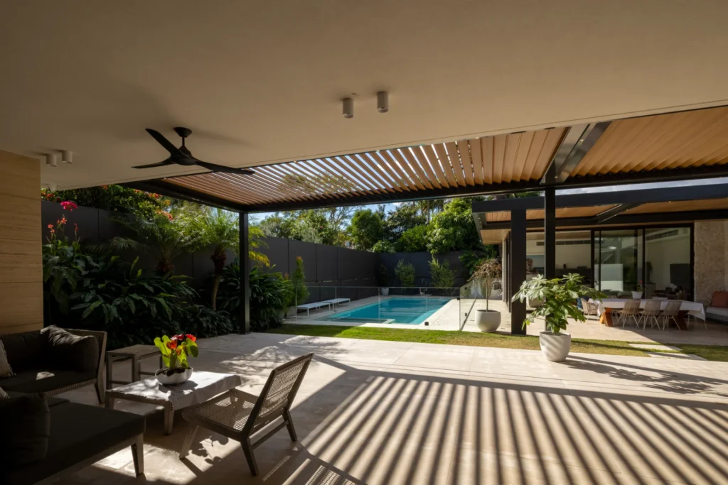 Sun casting shadows through the opening roof louvres.